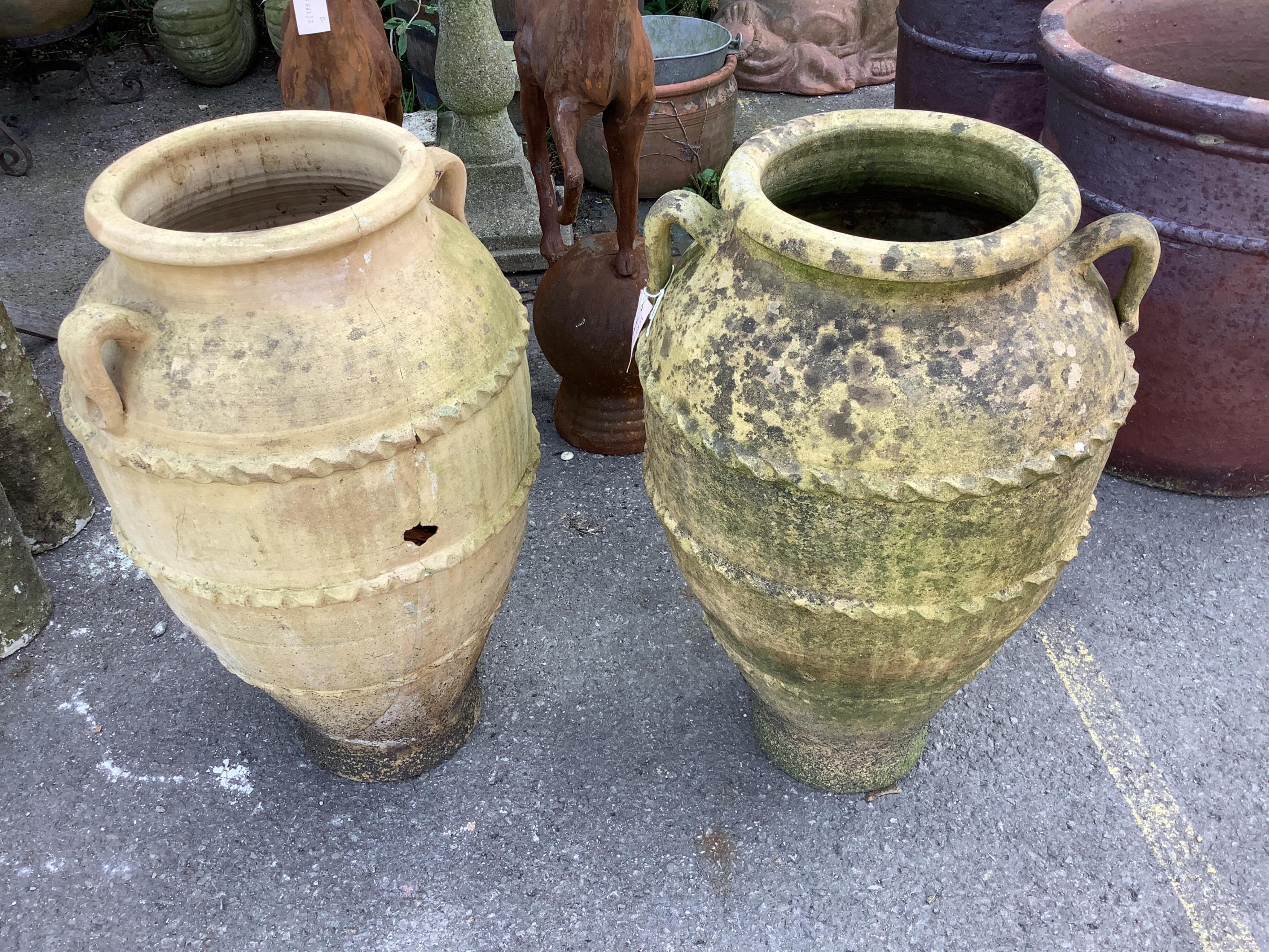 A pair of terracotta amphora style garden urns, height 68cm. Condition - weathered and one cracked